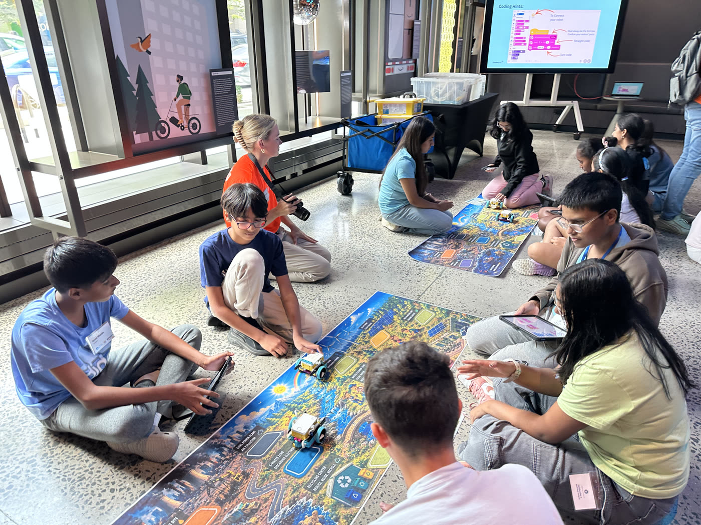 Co-ed cohort teams coding robots on challenge maps