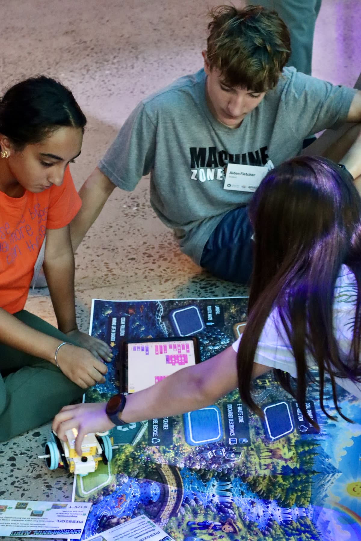 A mixed student team coding and testing their robot together
